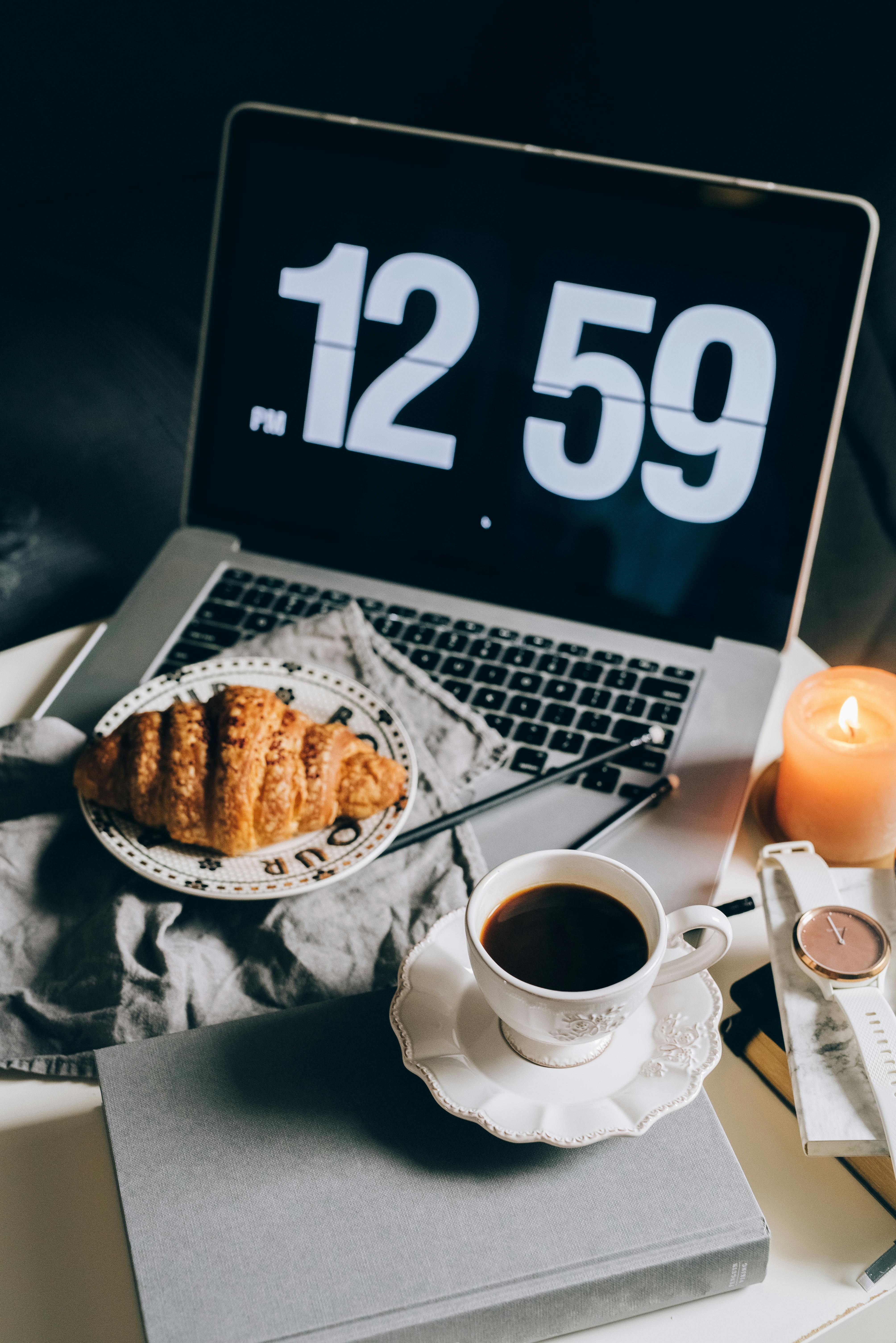 Croissant on a Saucer on a Laptop · Free Stock Photo