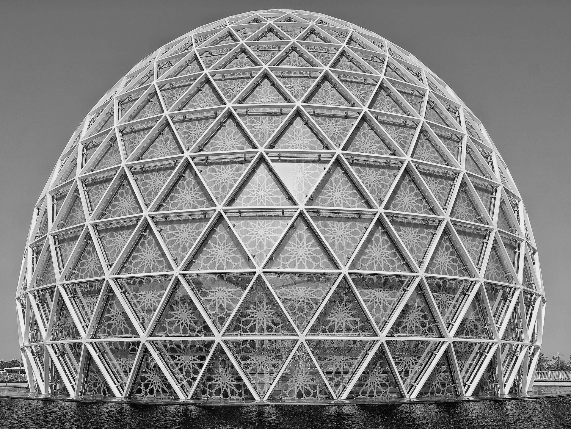 Black and white photo of a geodesic dome with intricate patterns and geometric design.