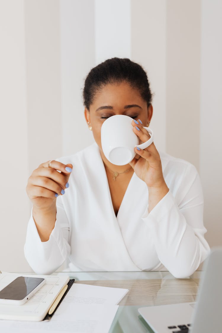 Woman In White Top Drinking From White Ceramic Mug