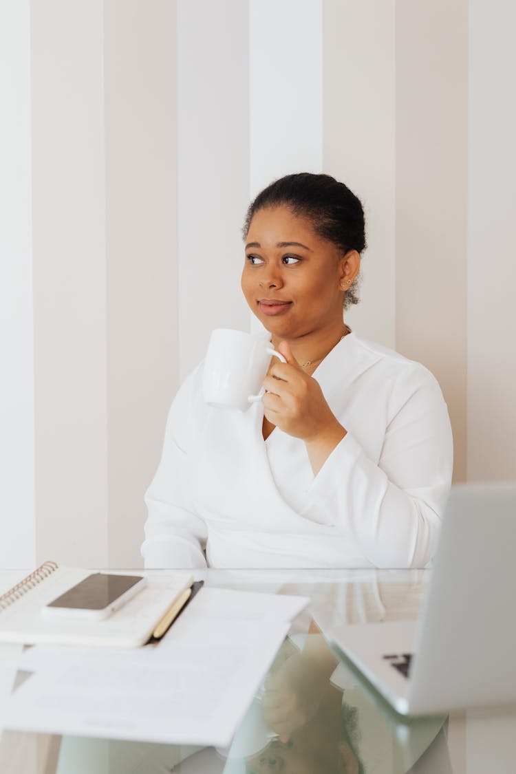 Woman In White Top Holding A White Mug