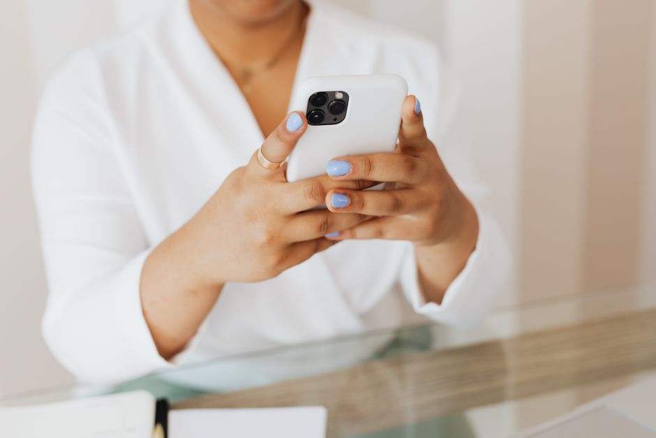 Person holding smartphone reviewing notifications