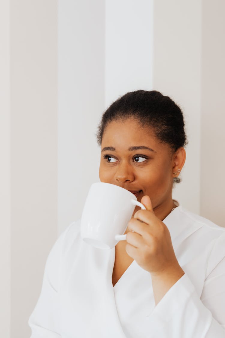 Woman In White Top Holding A White Mug