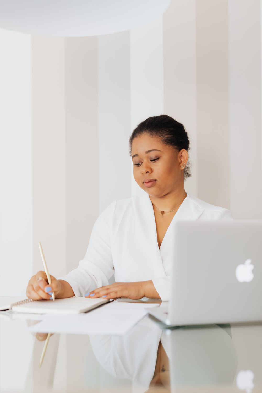 Woman in White Top Writing on Notebook · Free Stock Photo