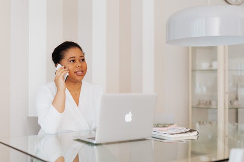 Woman in White Top Talking on Cellphone