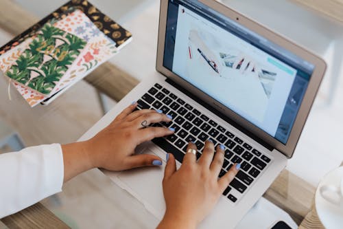 Close-Up View of Person Using a Laptop