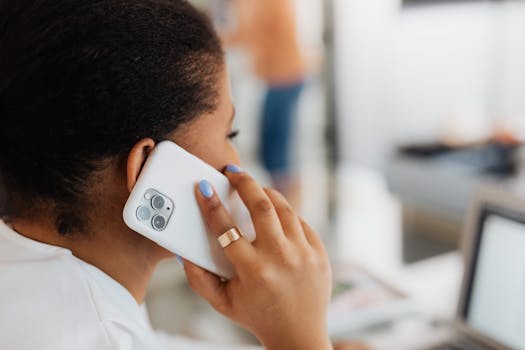 Close-up of a young woman talking on a smartphone indoors.