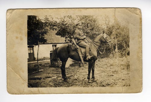 Sepia Photo of Man Riding a Horse