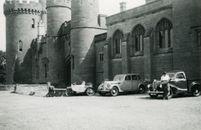 Grayscale Photo of Cars Parked Near a Building