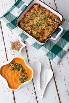 Mouthwatering baked casserole and creamy carrot soup with herbs. Perfect for cozy dinners.