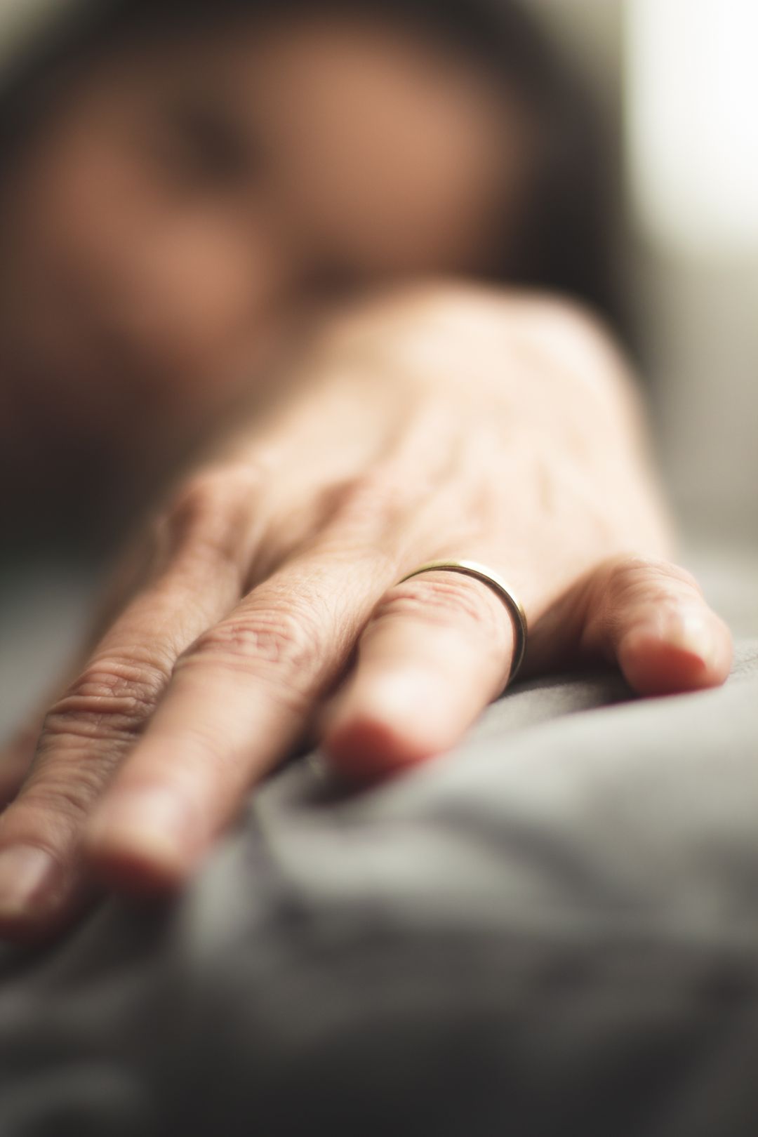which goes first engagement ring or wedding band — plain gold men's wedding band on a man's hand — FoundryCut