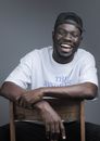 Cheerful black man sitting on chair