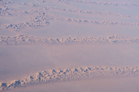 A sweeping aerial view of the Al Wahat Al Dakhla Desert in Egypt's New Valley Governorate.