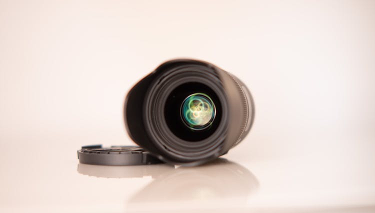 Lens Of Professional Photo Camera On White Surface