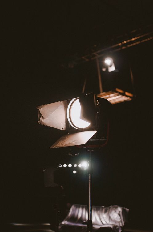 Bright spotlight glowing in dark room · Free Stock Photo