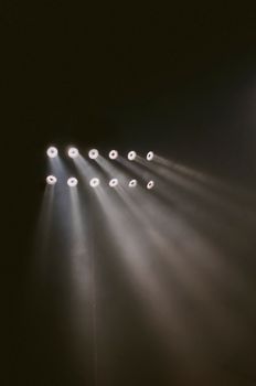 Powerful stage lights creating dramatic beams in a dark atmosphere. Perfect for theater and concert visuals.