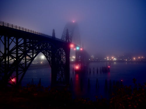 Bridge with lights in foggy evening