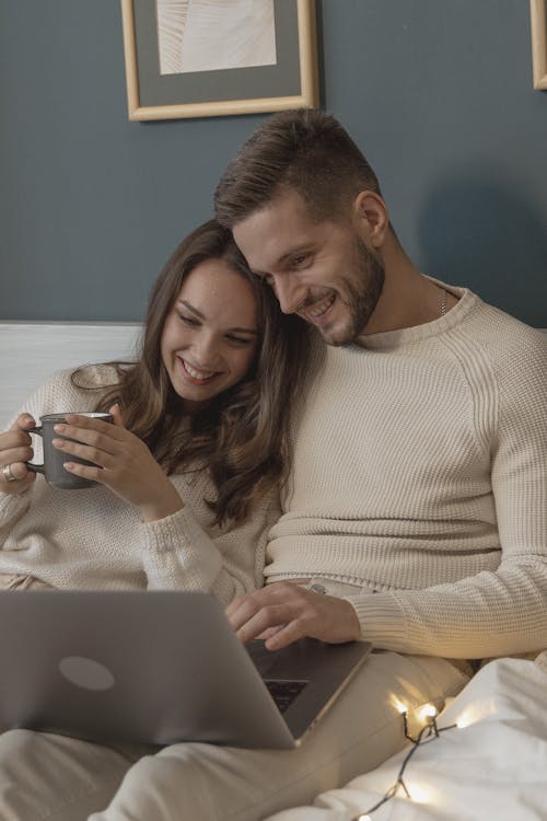 Woman in White Sweater Holding White Ceramic Mug Beside Woman in White Sweater