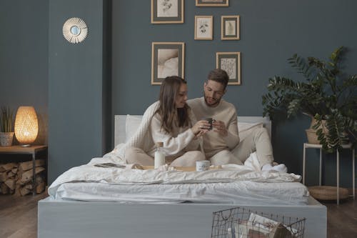 Free Couple Eating Breakfast in Bed Stock Photo