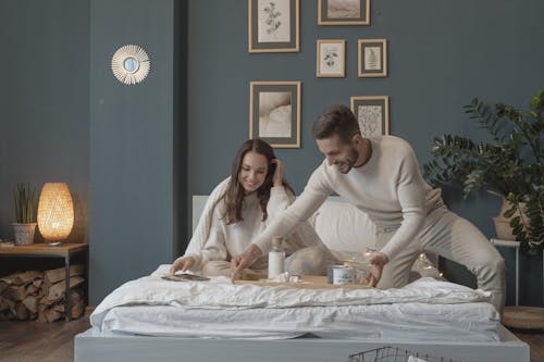 Free A Man Serving Breakfast in Bed Stock Photo