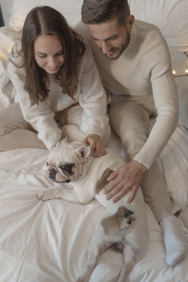 A Couple Cuddling Their Cute Dog