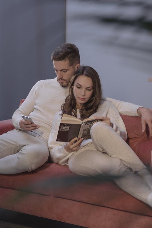 Free A Couple Sitting on Couch Next to Each Other Stock Photo