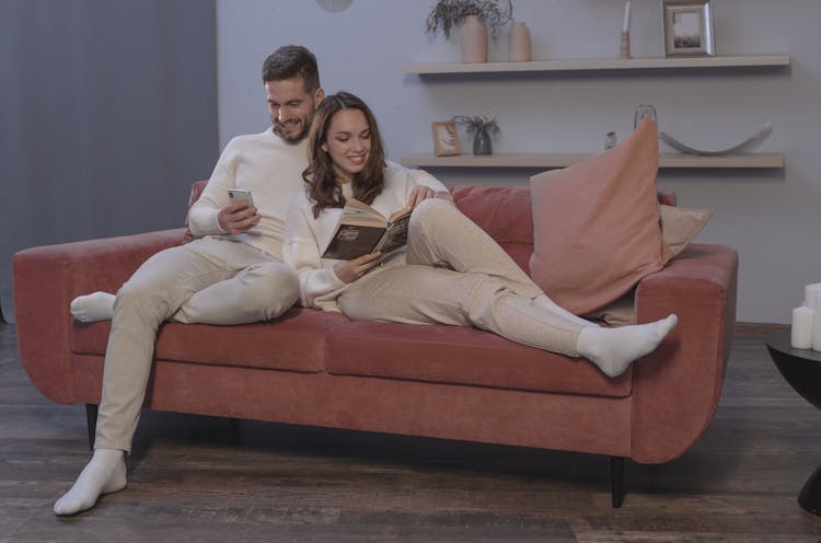 A Happy Couple Sitting On A Couch