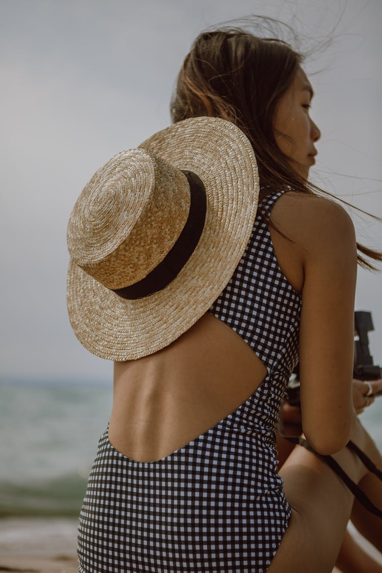 Slim Asian Woman Chilling On Beach On Sunny Windy Day