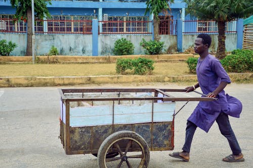 Free Man Pushing Cart Stock Photo