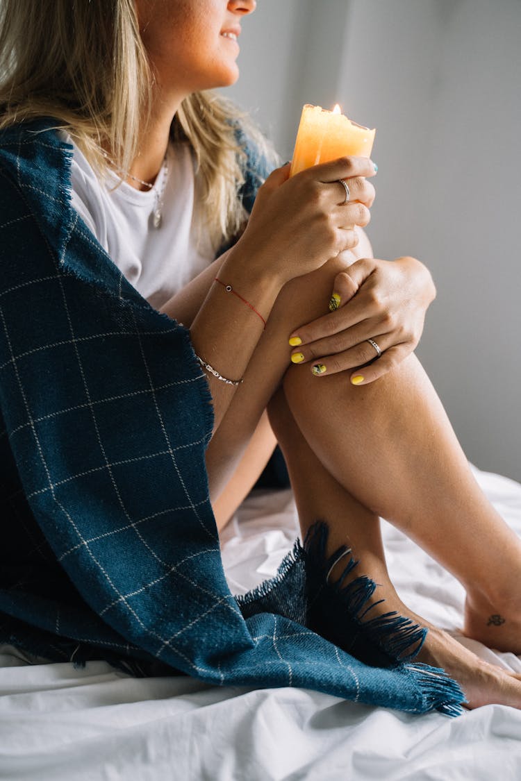 Woman Holding A Scented Candle