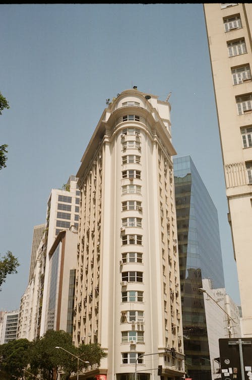 From below of contemporary multistage house facade under blue sky in town in daylight