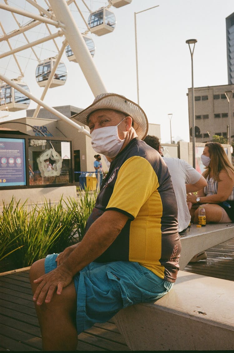 Anonymous Senior Man In Sterile Mask On Street Cement Bench