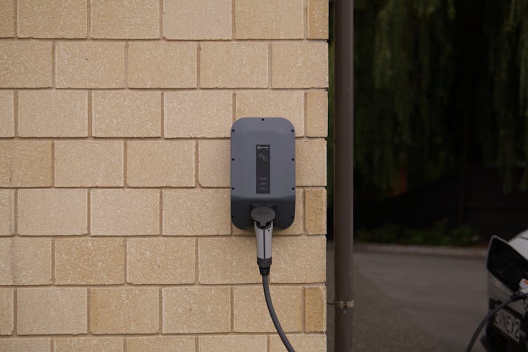 An Electric Car Charger On A Wall