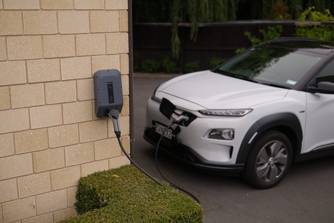 Free Black Charger Plugged-In on White Car Stock Photo electric car