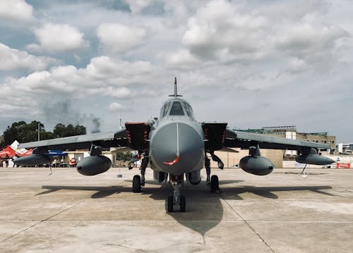 Gray Military Warplane Under Cloudy Sky