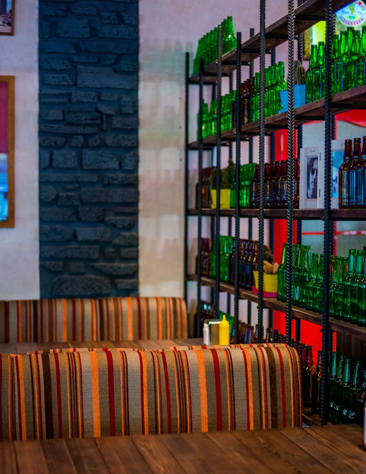 Bar Wall Decoration From Empty Bottles On Shelves 