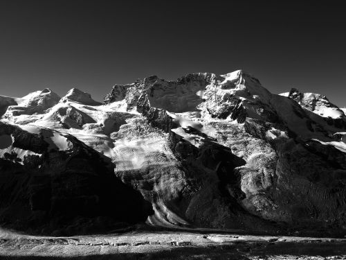 Free A stunning black and white photograph of snow-covered mountains in Switzerland. Stock Photo