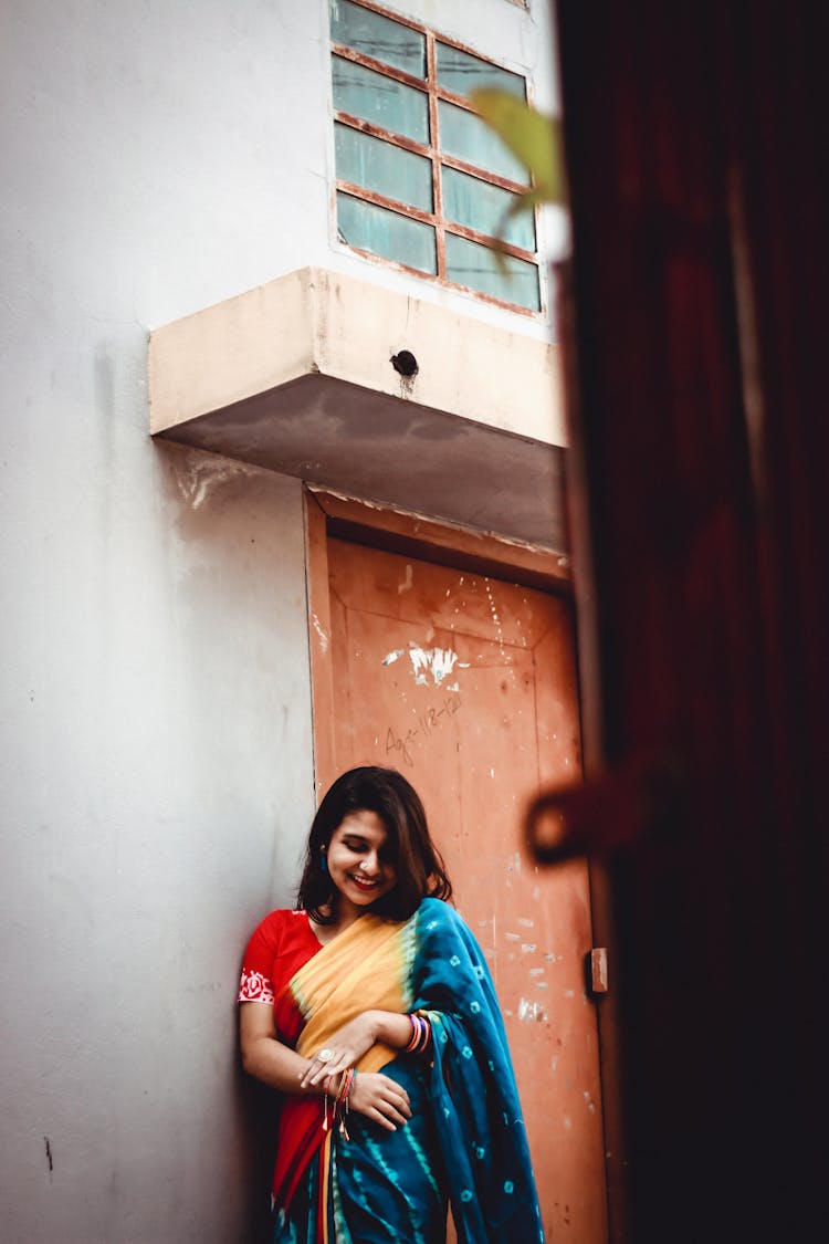 Cheerful Ethnic Woman Laughing Near Shabby Building