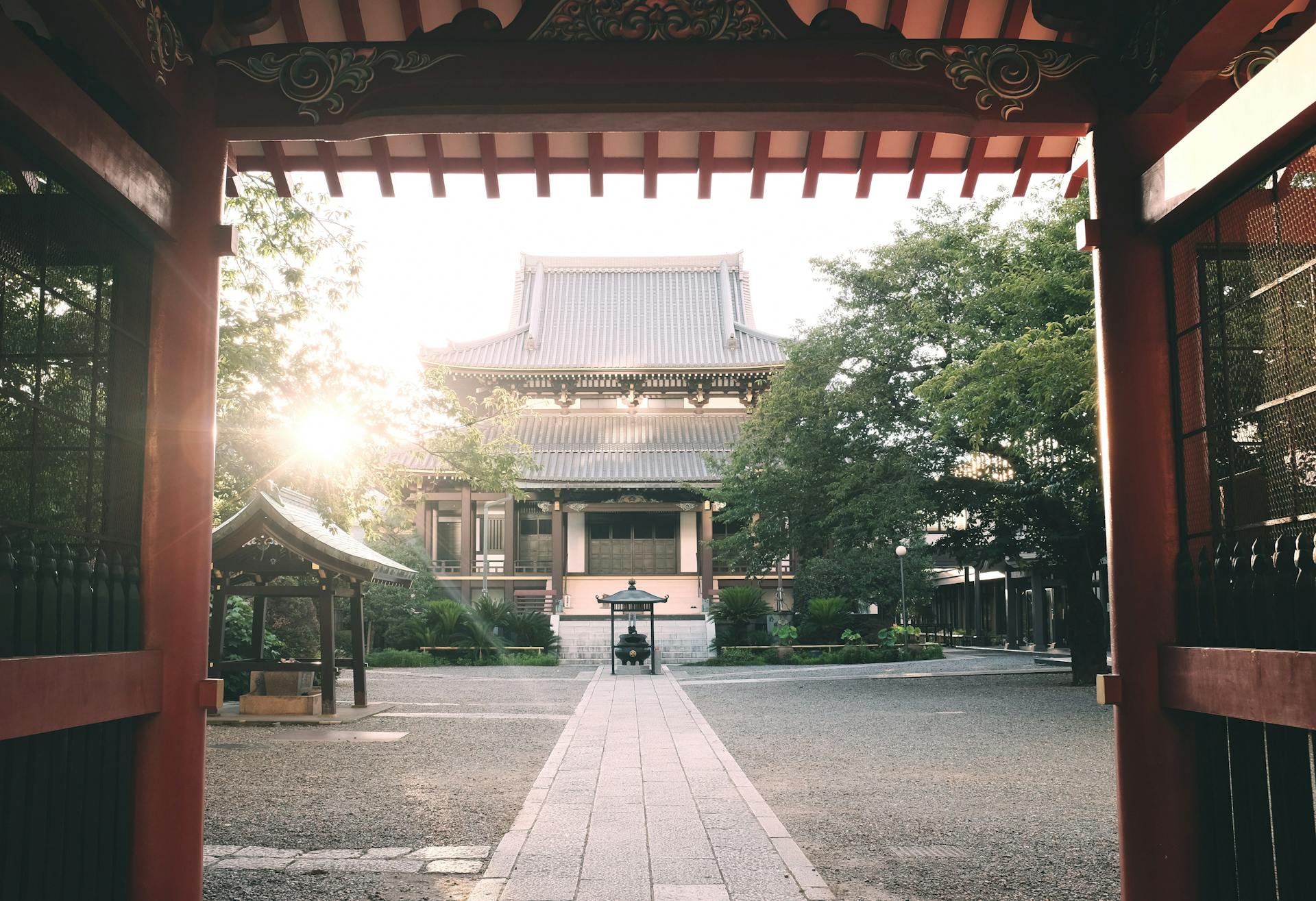 Serene view of a traditional Japanese temple at sunrise in Tokyo, showcasing cultural architecture and tranquility.