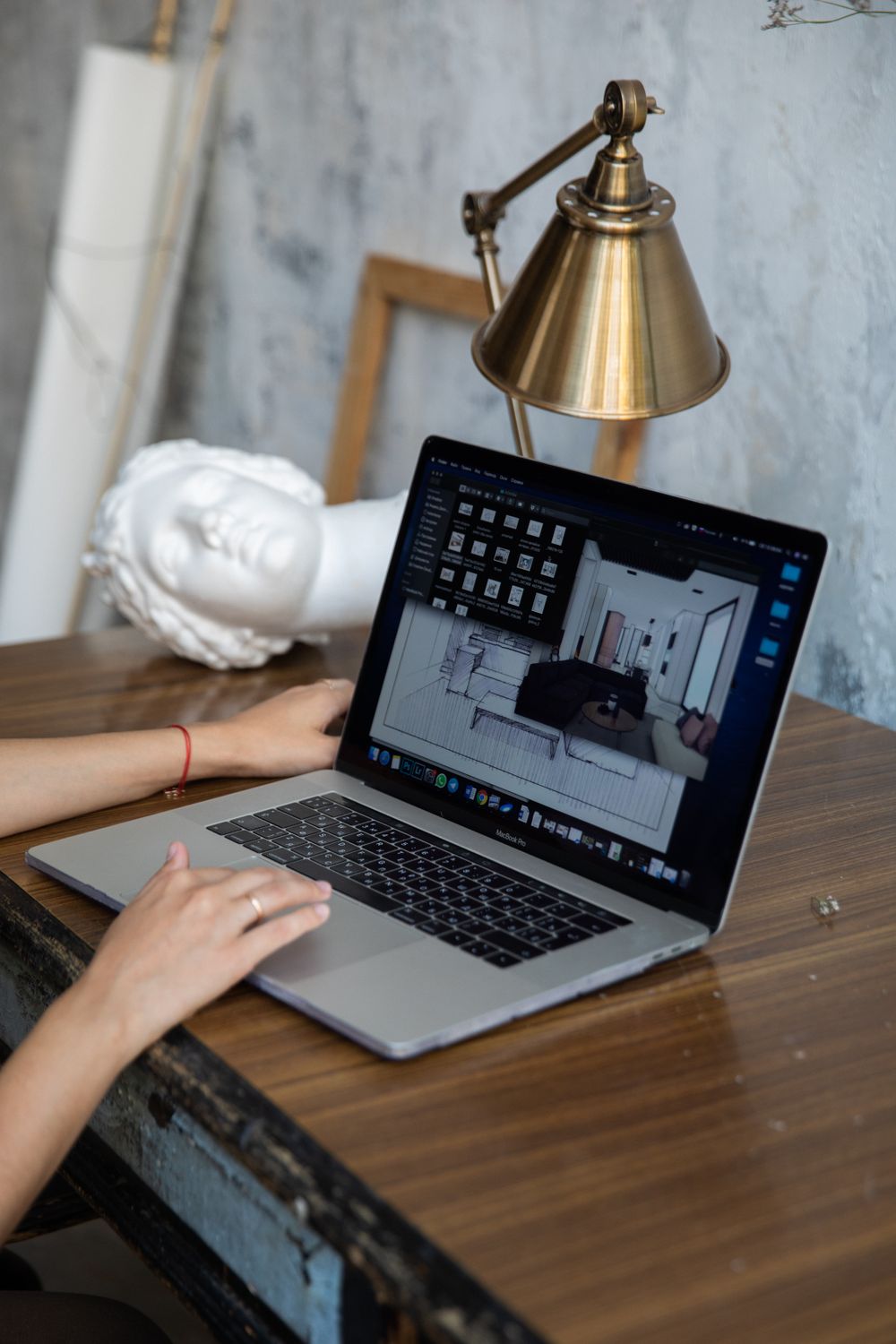 Person Using Macbook on Brown Wooden Table · Free Stock Photo