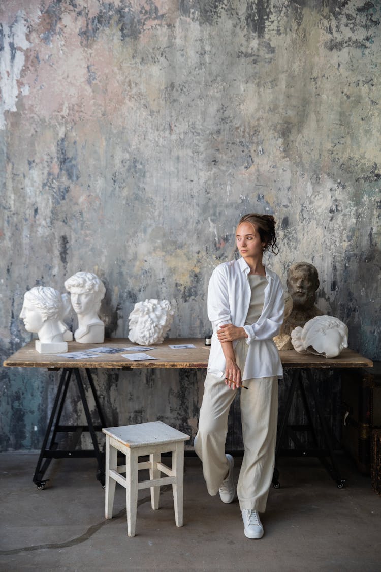 Sculptor Posing In A Studio