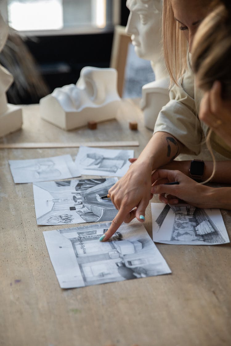 Woman Pointing With A Finger On A Drawing