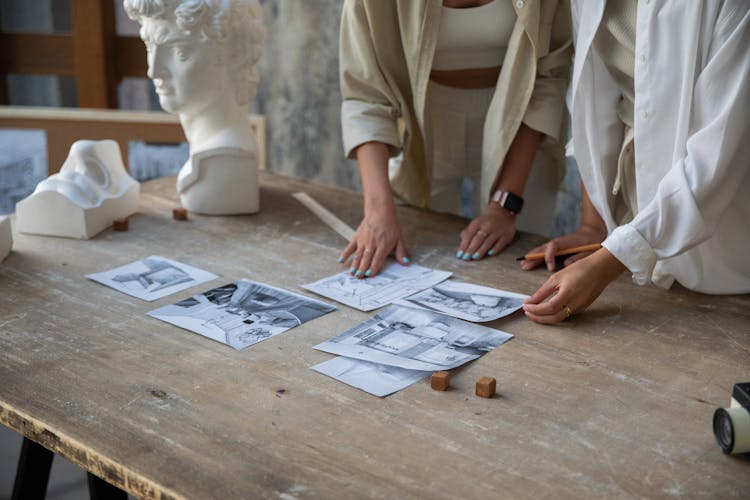 Pencil Drawings On Wooden Table And Women Hands