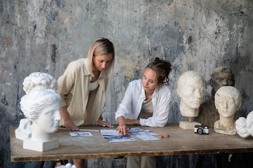 Women in Art Studio Discussing Project Ideas