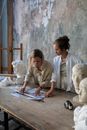 Woman in White Robe Sitting Beside White Dog