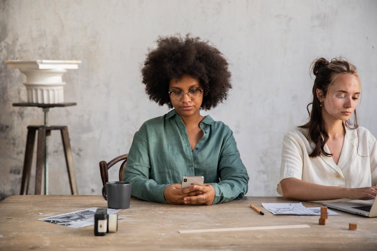 Women Sitting While Using Gadgets