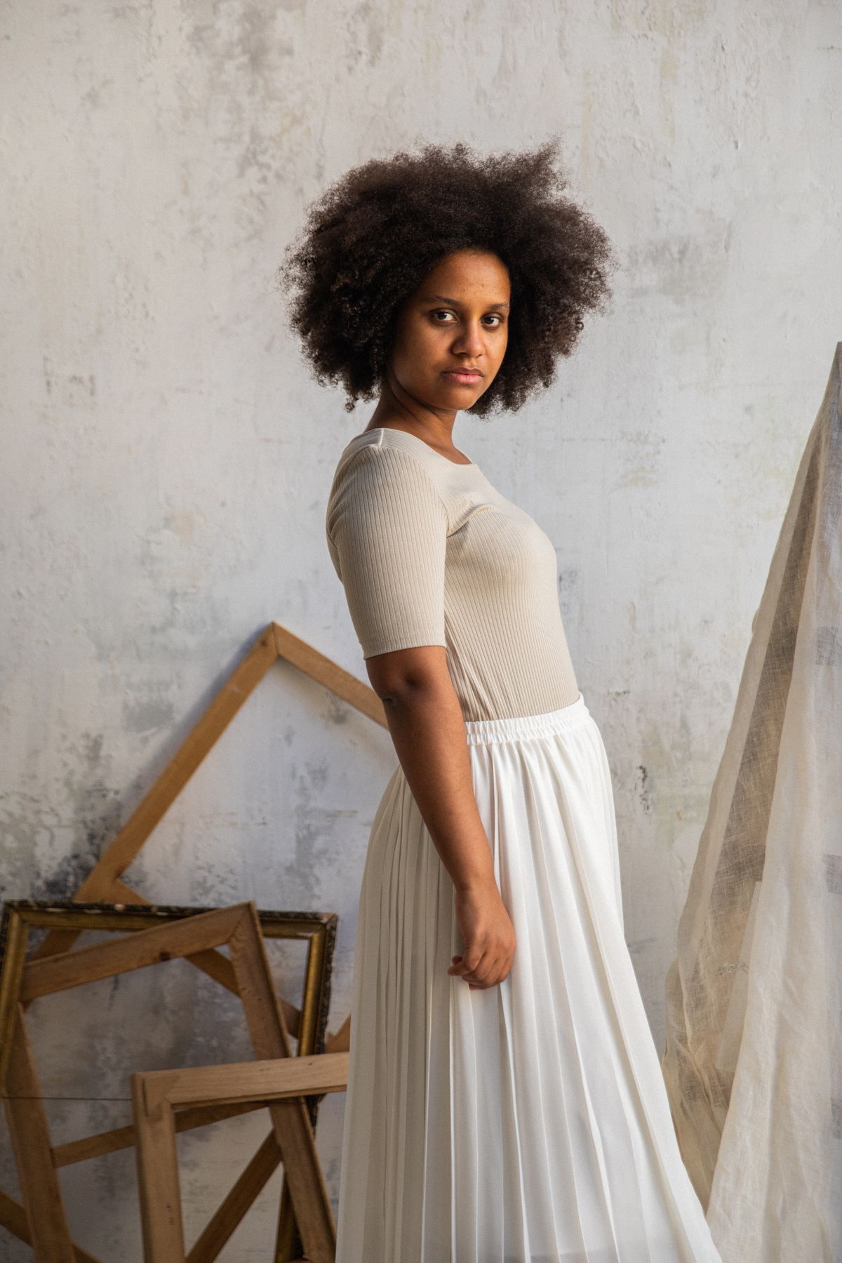 Élodie pleated skirt in ivory worn with a beige top