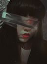 Anonymous woman covering eyes with crystal