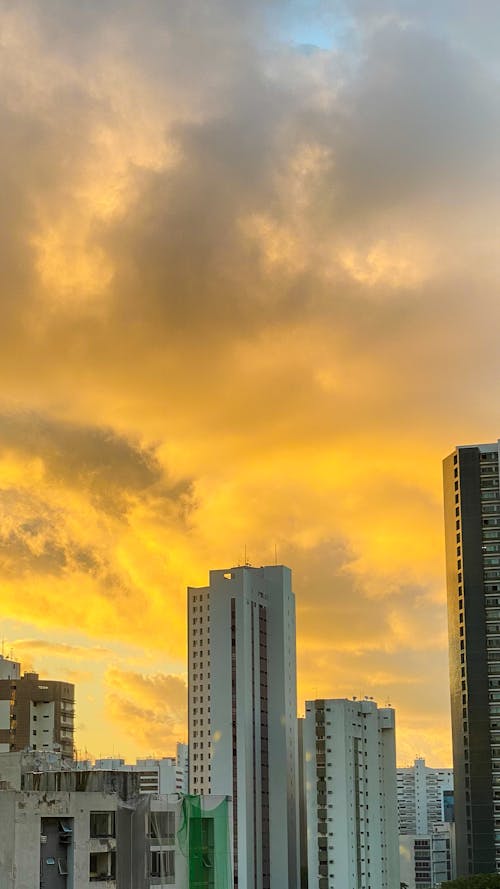 High-Rise Buildings Under Orange and Yellow Sky during Sunset