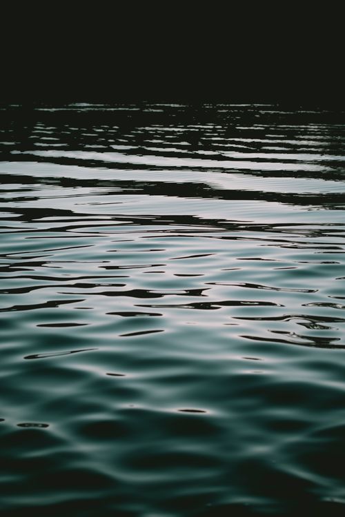 Free Capture the peaceful essence of rippling water with a reflection in this serene photograph. Stock Photo