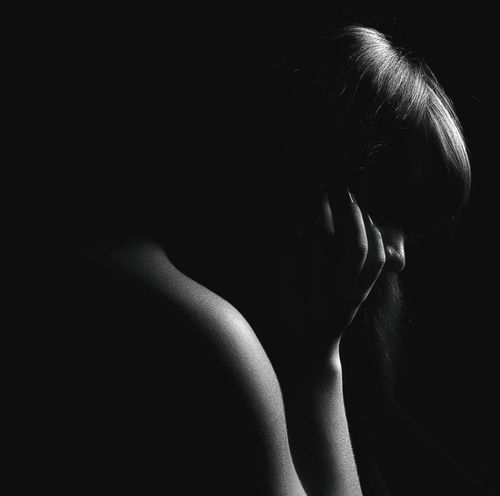 Free Dramatic black and white silhouette of a woman in deep thought. Stock Photo
